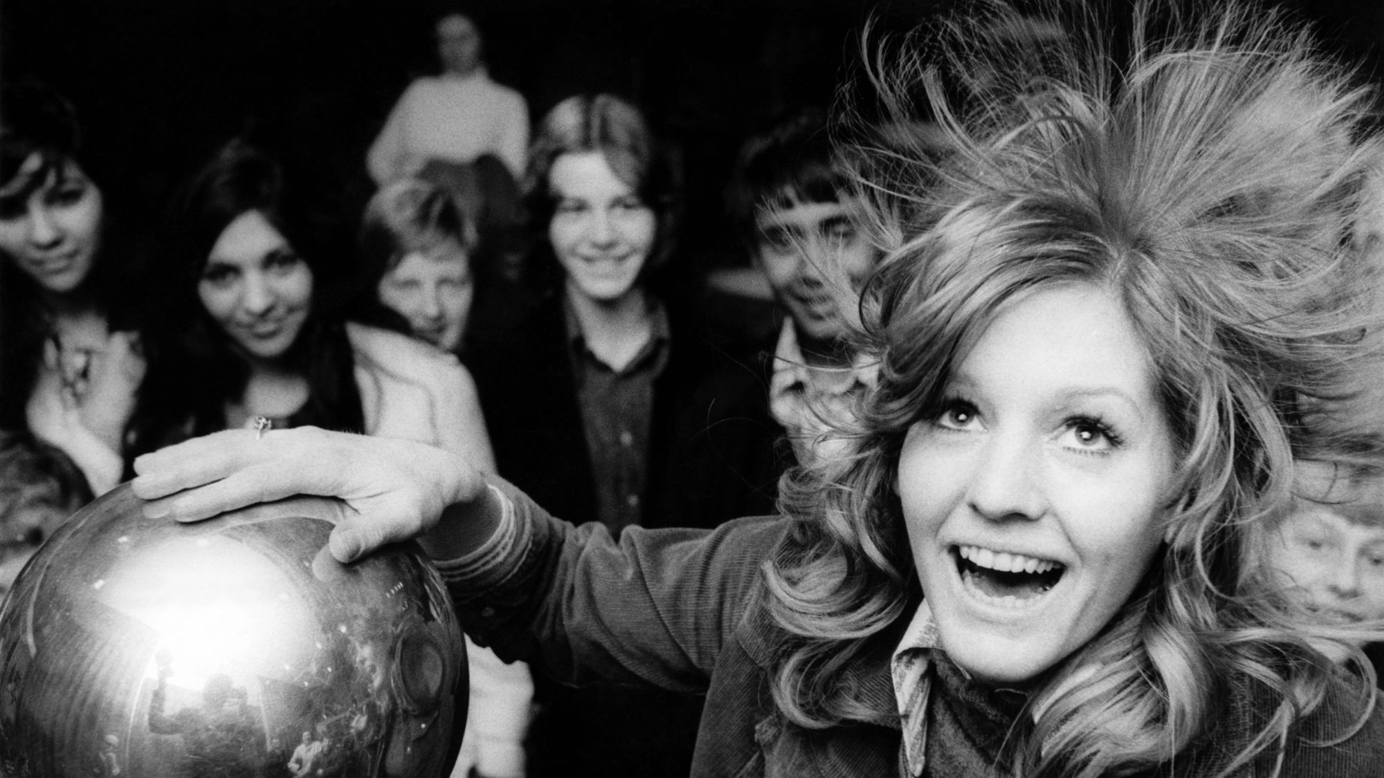 a girl with static hair after touching a Van de Graaff generator