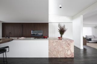 A kitchen with white and pink marble countertop