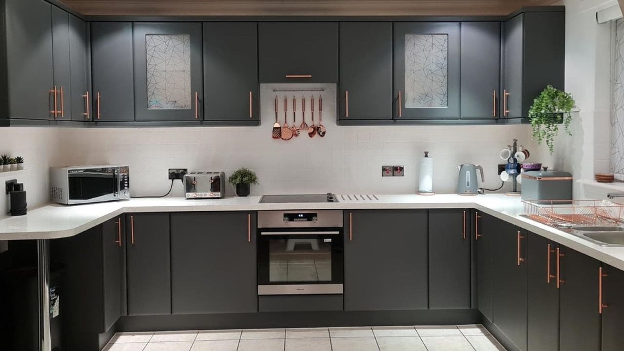 painted grey kitchen with copper accessories