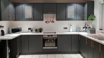 kitchen with painted grey cabinets and copper accessories