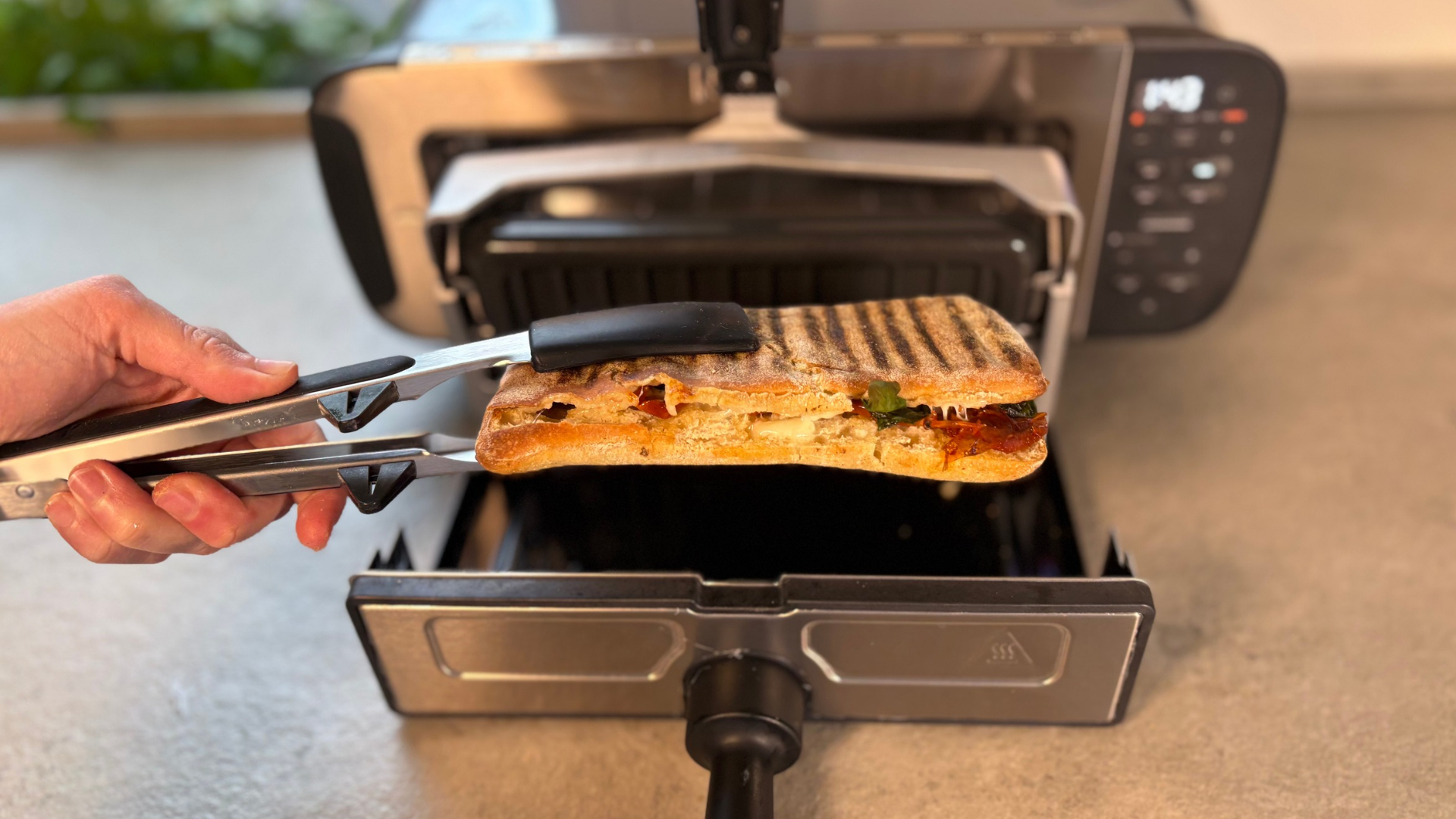 Testing the Ninja Foodi 3-in-1 Toaster Grill Panini Press on the counter making a panini
