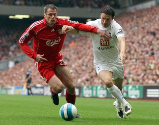 Jamie Carragher vies for the ball with Robbie Keane in a Premier League match between Liverpool and Tottenham in October 2007.