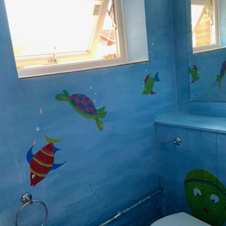 before shot of a downstairs loo with painted fish