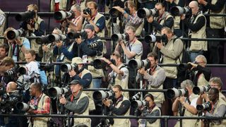 D69BEK Photographers seen on the stands during the Woman's 100m Final during the London 2012 Olympic Games Athletics, Track and Field events at the Olympic Stadium, London, Britain, 04 August 2012. Photo: Michael Kappeler dpa +++(c) dpa - Bildfunk+++