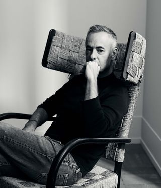 Costa Brazil founder Francisco Costa in a 1930s Danish wingback chair in his New York apartment
