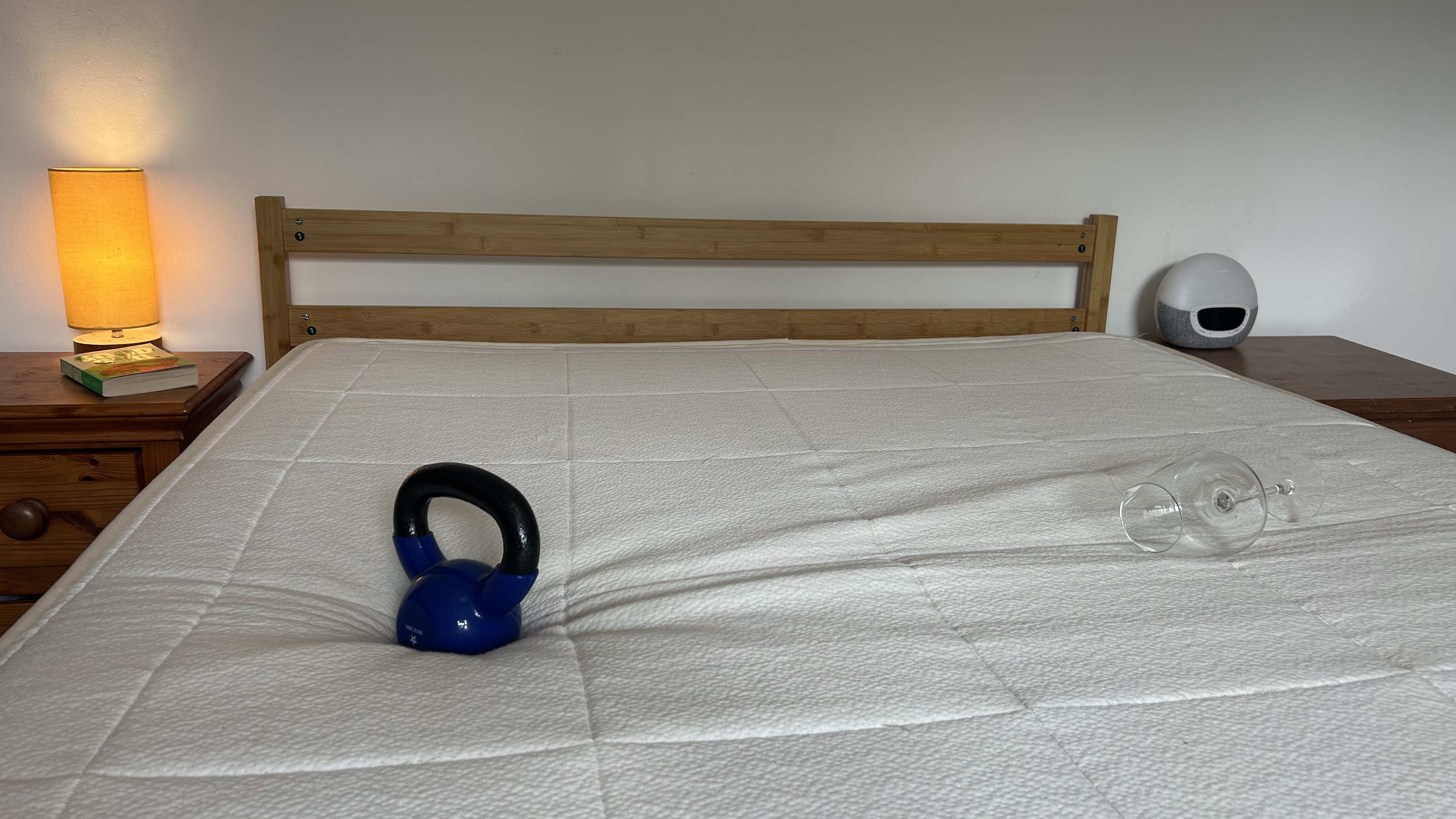 A weight next to a wine glass that's lying on its side after testing for motion isolation