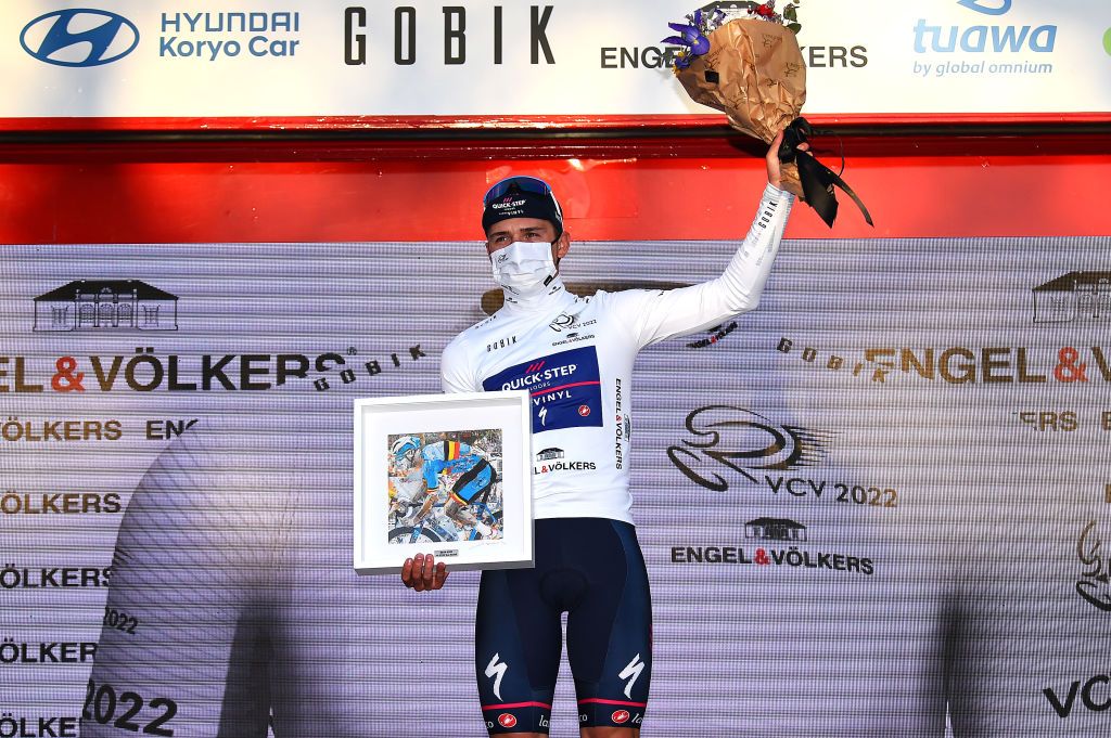 VALENCIA SPAIN FEBRUARY 06 Remco Evenepoel of Belgium and Team QuickStep Alpha Vinyl celebrates winning the white best young jersey on the podium ceremony after the 73rd Volta A La Comunitat Valenciana 2022 Stage 5 a 92km stage from Paterna to Valencia VCV2022 on February 06 2022 in Valencia Spain Photo by Dario BelingheriGetty Images