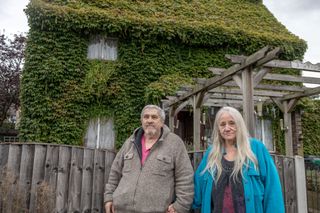 Couple Michael and Teresa stand outside their Virginia creeper covered home