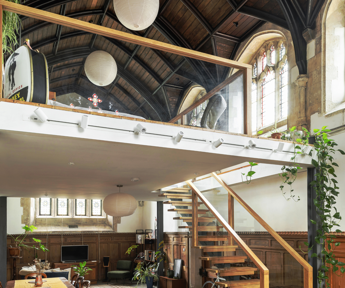 Mezzanine with glass banister and stained glass windows to the right and back