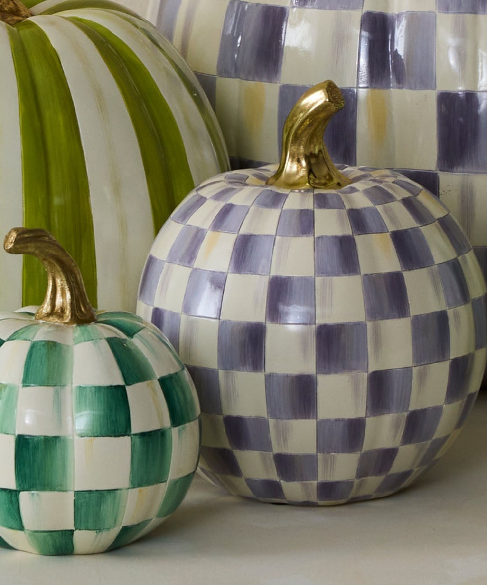 Painted resin pumpkins with green and violet checkerboard designs