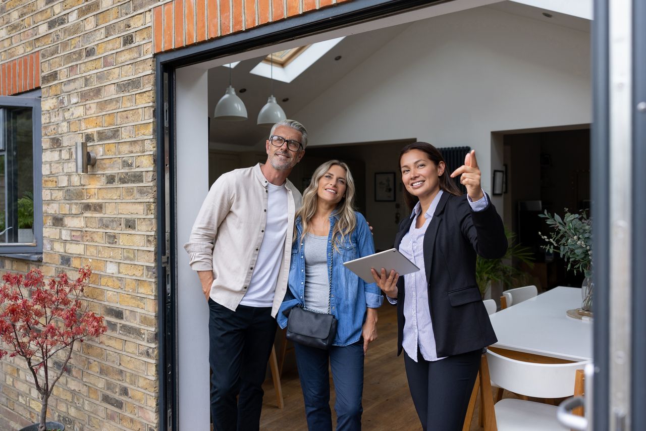 Estate agent showing a house for sale to a couple