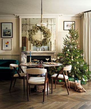 dining table with round marble table and wooden chairs and christmas tee and wreath