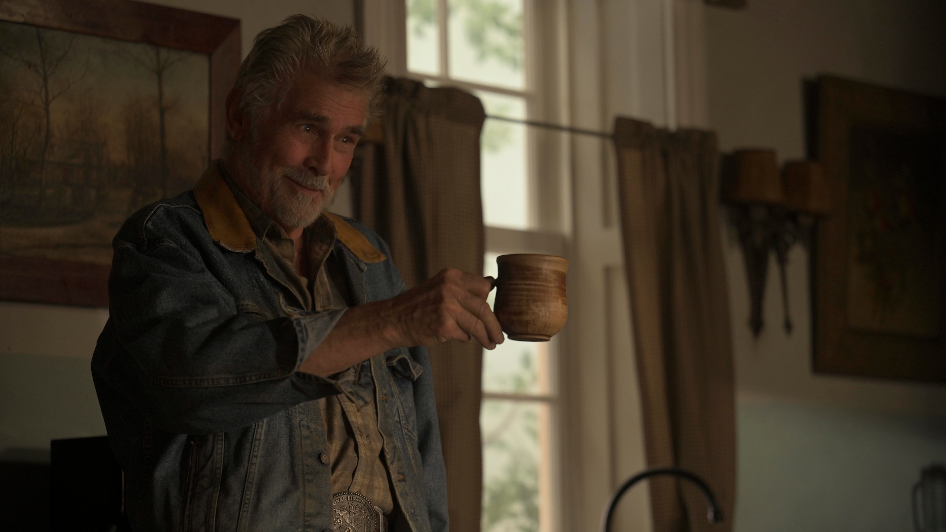 Cap raises his mug and smiles in Ransom Canyon season 1