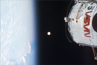 The crew of a 1999 servicing mission spotted Earth, the moon, and part of the Hubble Space Telescope.