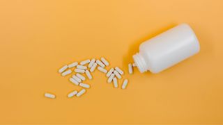 Magnesium supplements spilling out of bottle