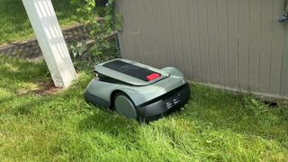 ECOVACS GOAT robot lawn mower in tight crevice