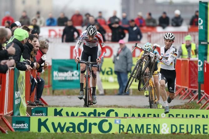 Mathieu van der Poel bunny-hops the barriers while German champion Philipp Walsleben opts to run them