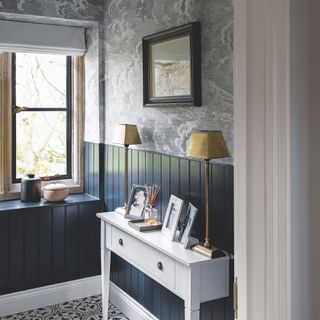 hallway with cloud wallpaper and navy wood panelling