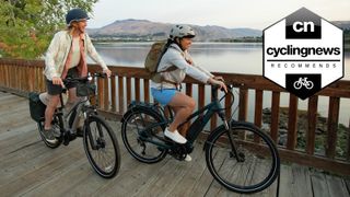 Two cyclists riding electric bikes in nature