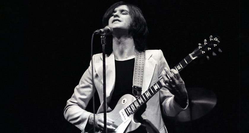 A black-and-white image of Dave Davies of the Kinks performing with a Goldtop Les Paul in 1974