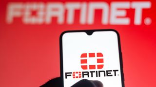 Fortinet logo and branding displayed on a smartphone screen with brand name blurred in background.