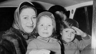Princess Margaret sits in the backseat of a car with her children David and Sarah