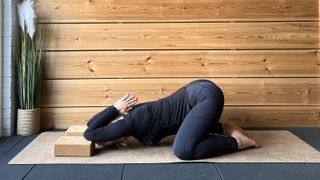 Kristina Rihanoff demonstrates puppy pose with yoga block