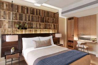 Hotel bedroom with reclaimed headboard