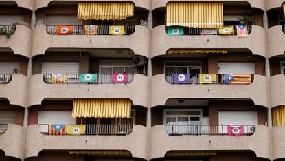 An apartment block bedecked with Catalan flags and pro-independence banners in Barcelona