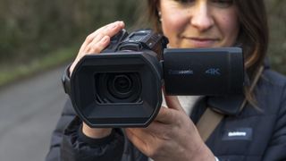 The Panasonic HC-X1500 camcorder in a female photographer's hands