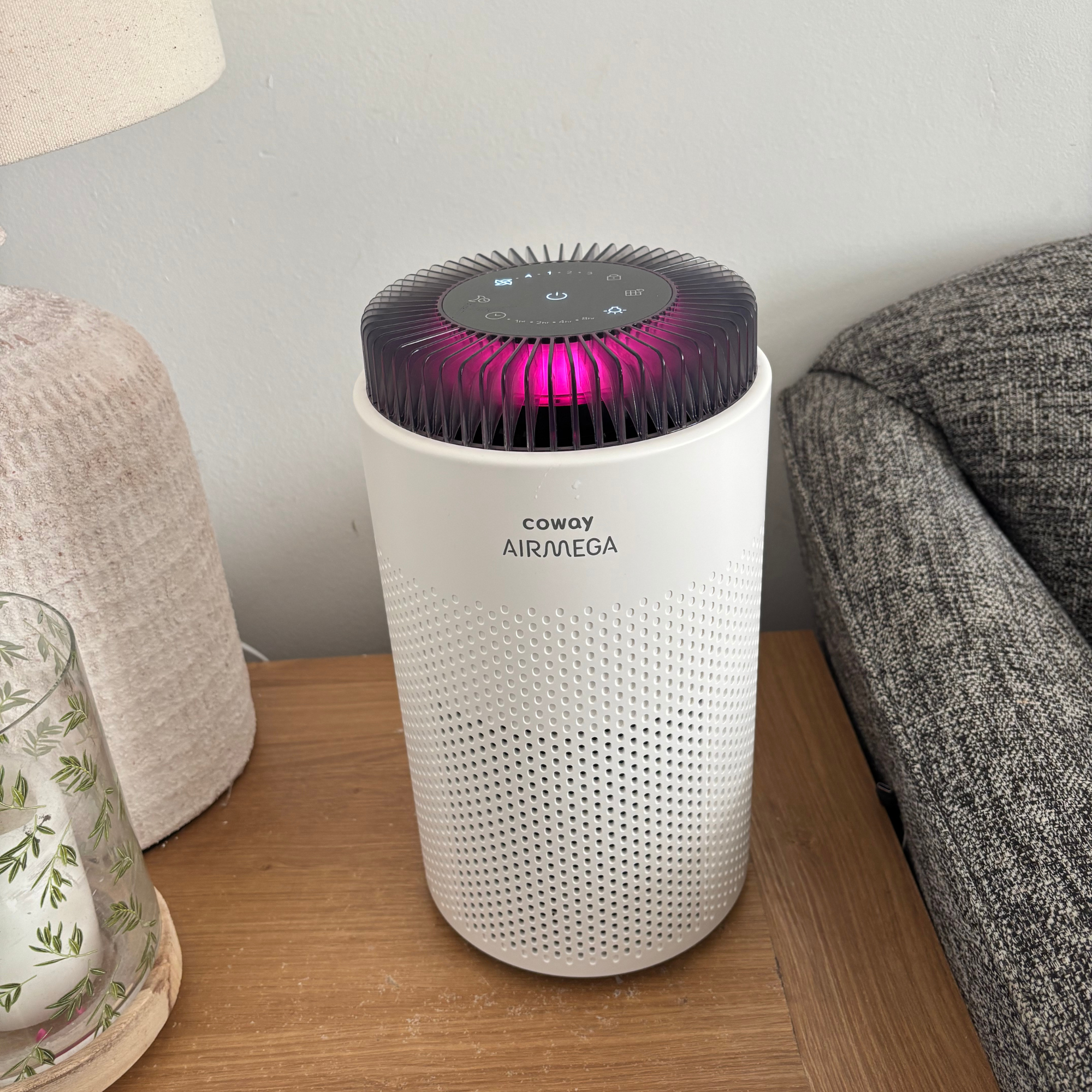 Coway Airmega 50 on side table with pink light indicator displayed