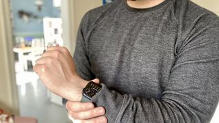Close up of a man wearing an Apple Watch on his wrist.