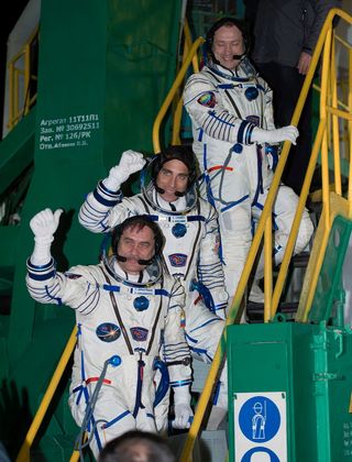 Expedition 35 Crew Waves from Stairs