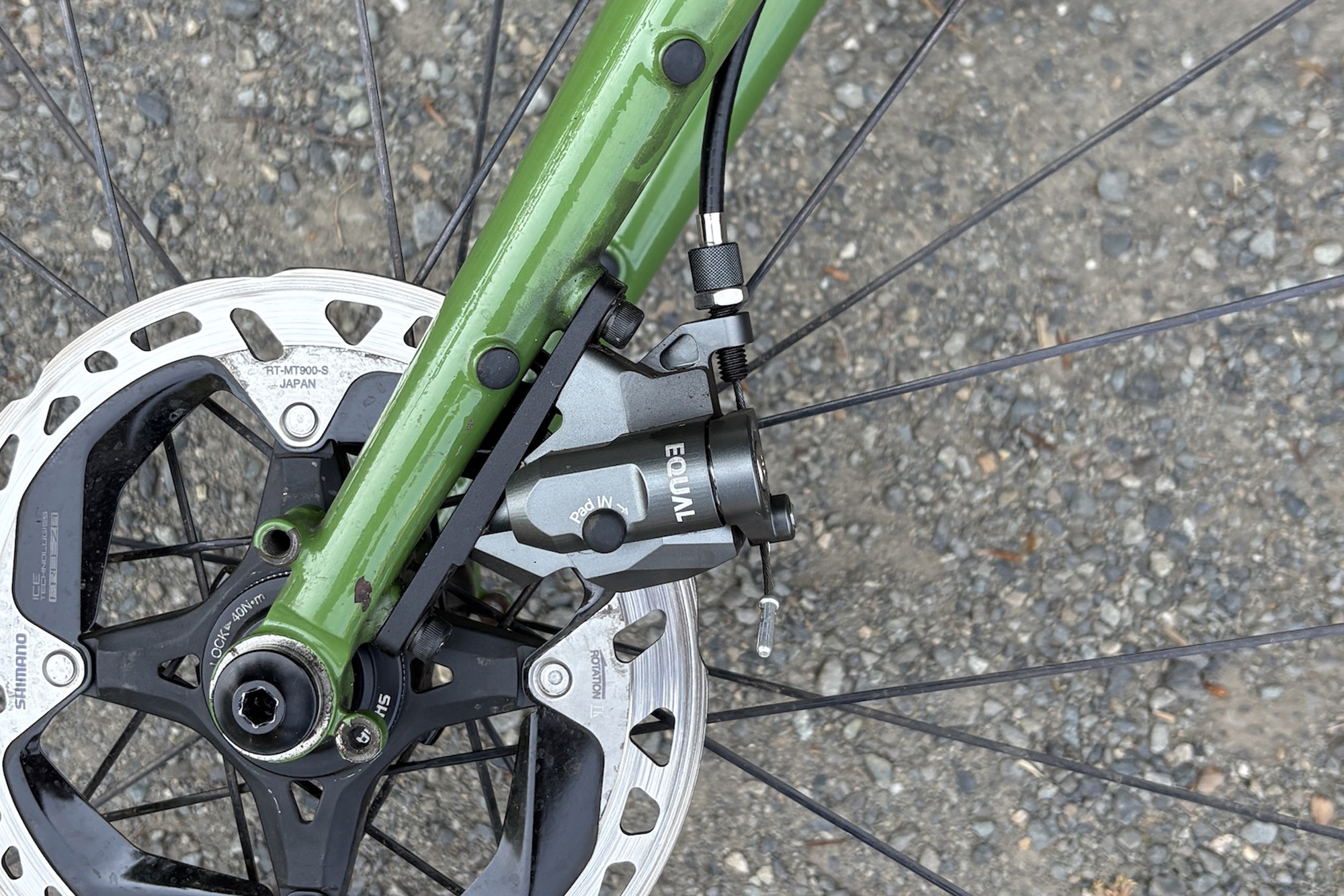 Growtac Equal mechanical disc brake mounted to a green steel fork leg and using shimano disc rotors