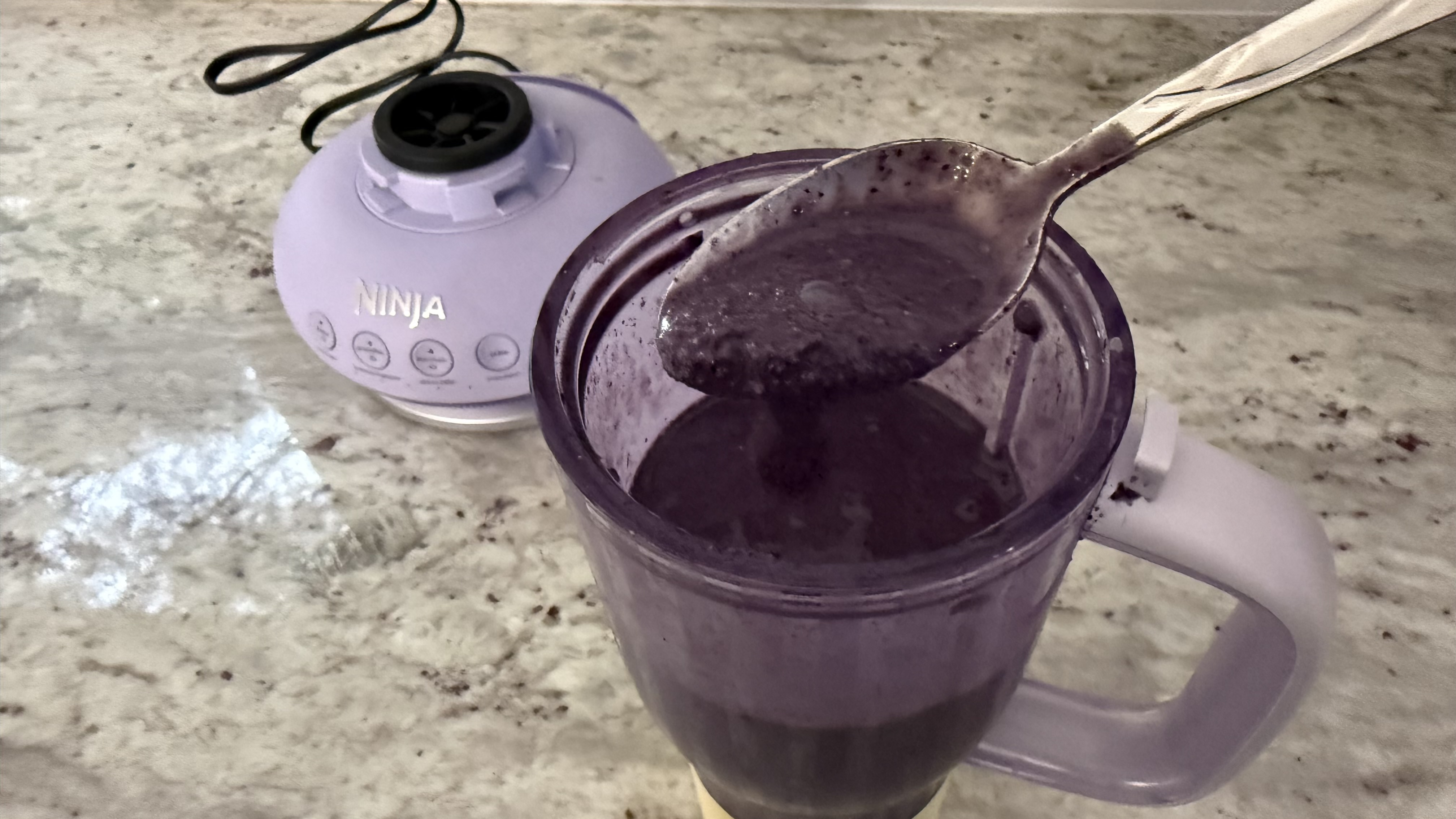 Ninja BlendBOSS&trade; Tumbler Blender with 26oz Travel Tumbler making banana, blueberry, and spinach smoothie