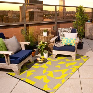 Outdoor patio with furniture and lime grey rug