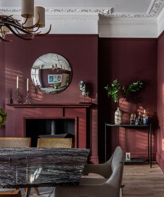 Putty white walls painted a deliciously dark red with mercurial magenta undertones for a dramatic transformation.