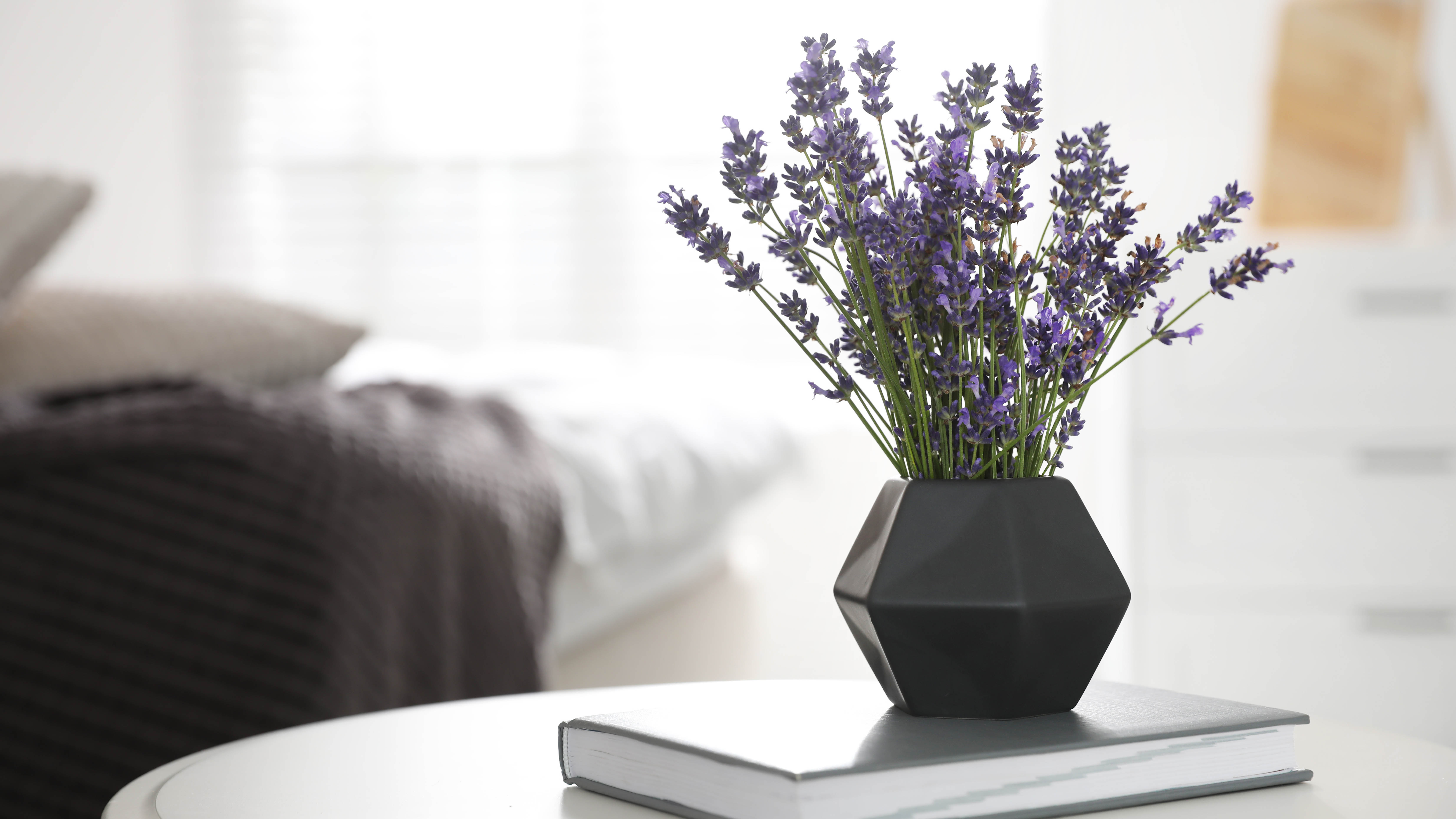 Vase full of lavender on a book on a table