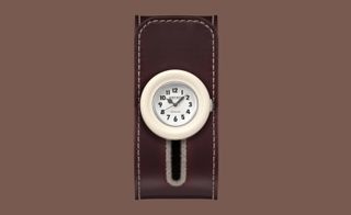 white watch face on brown leather strap