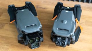 DJI Mavic 3 Pro next to Mavic 3 Thermal folded on desk