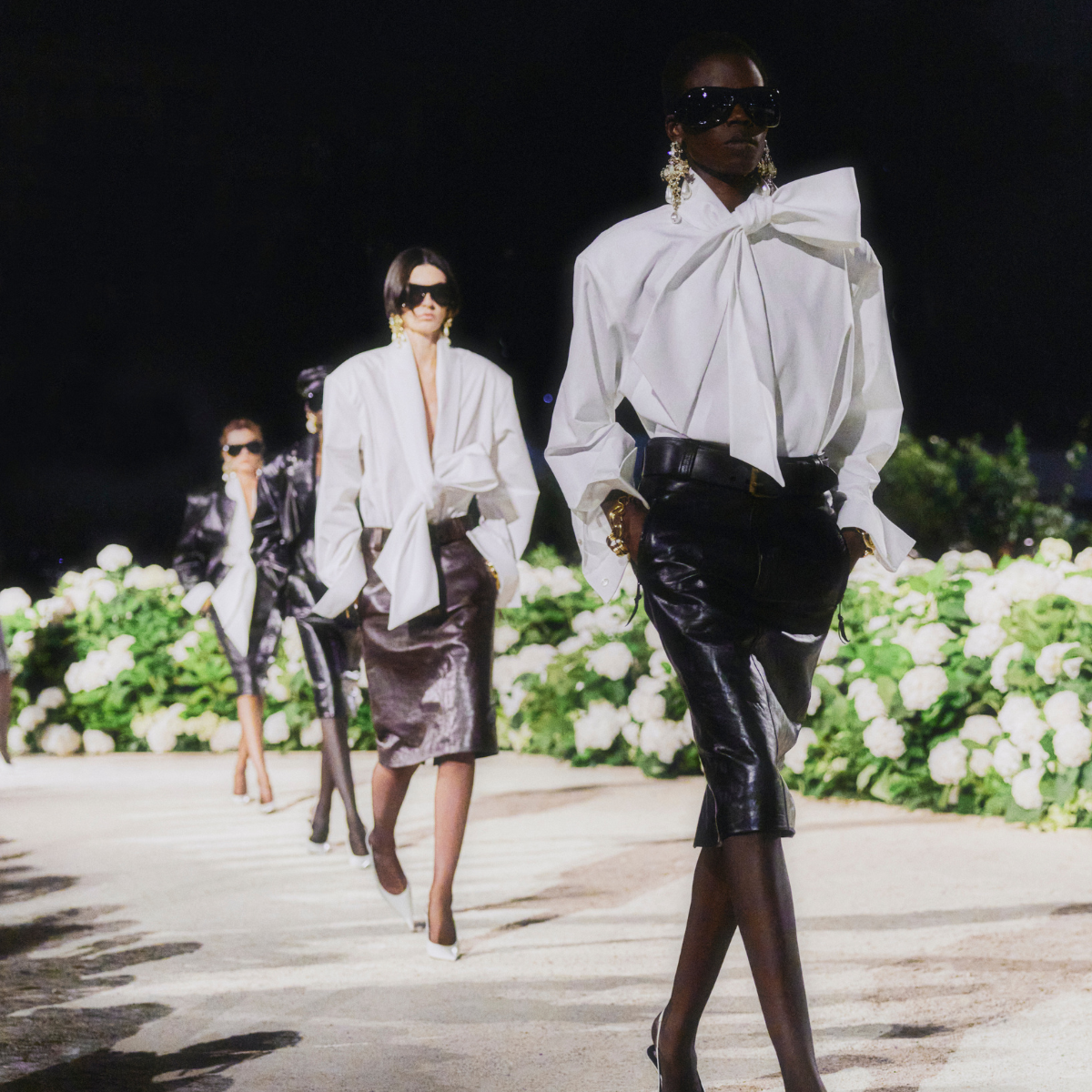 Saint Laurent SS26 runway shot x 4 models white shirt black leather skirt