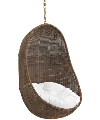 A deep egg-shaped chair with white inset cushion