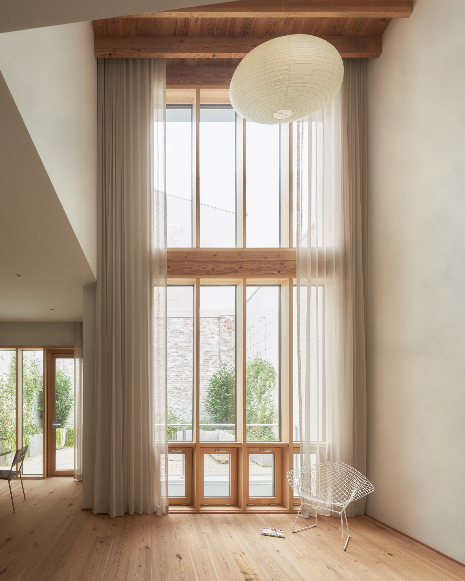 103 Grand by Of Possible, empty residential building with natural textures and high ceilings