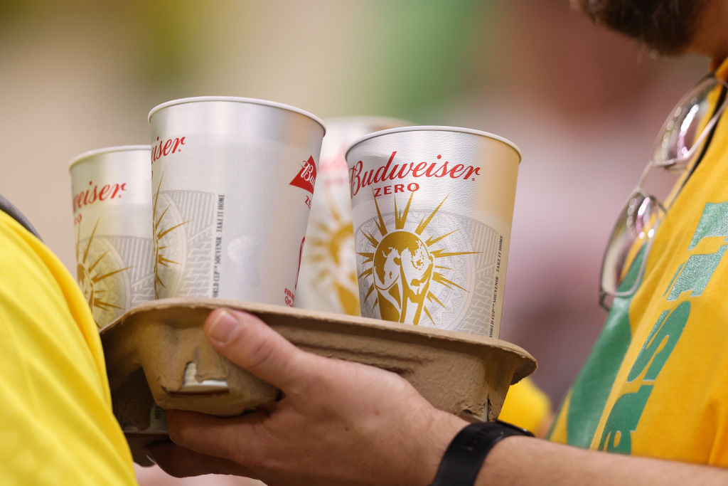 Brazil supporters carry cups of alcohol-free beer marked &quot;Budweiser Zero&quot; in the stands ahead of the FIFA World Cup Qatar