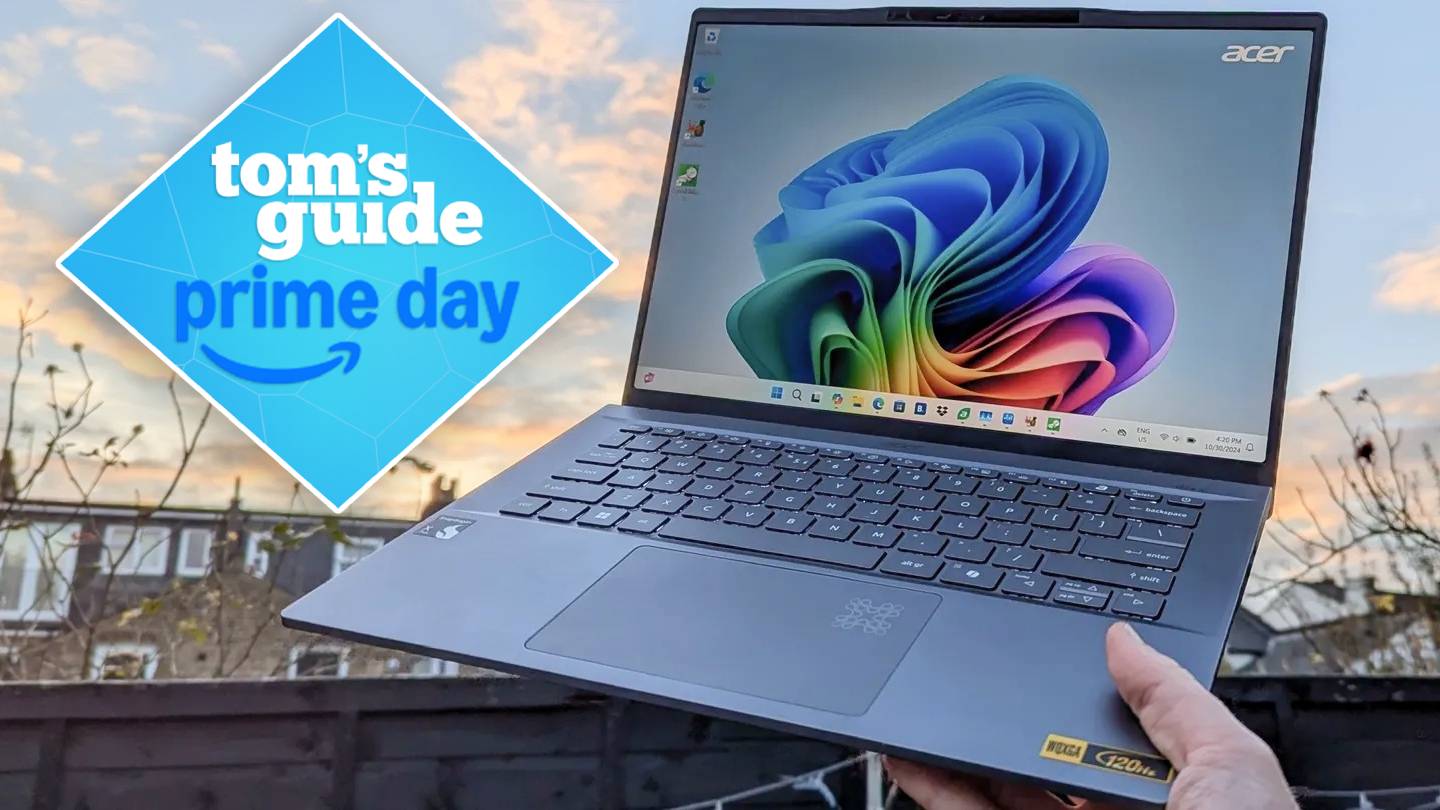 Hand holding Acer Swift 14 AI against sky with Tom's Guide Prime Day badge