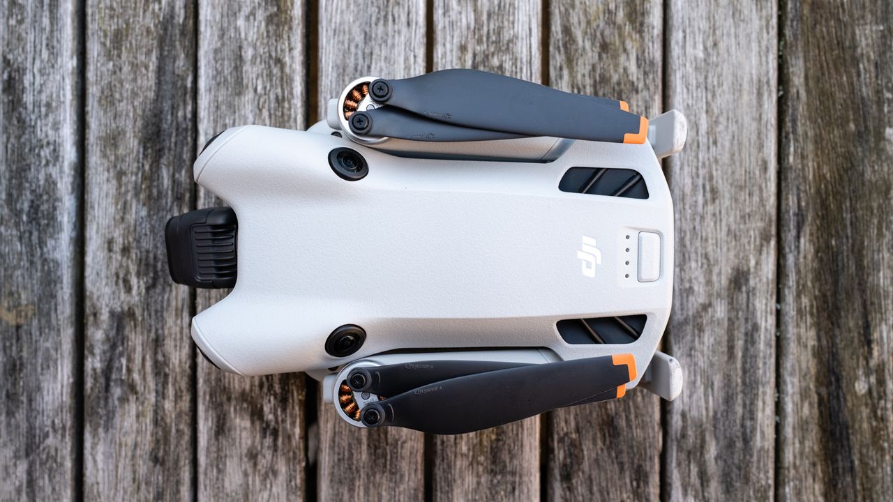 top-down view of a grey folded drone with black blades