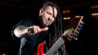 Five Finger Death Punch’s Zoltan Bathory posing for a photograph with a guitar in 2014