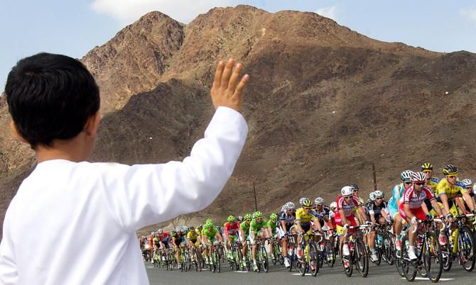 A local fan cheers on the riders on stage 3 of the Dubai Tour