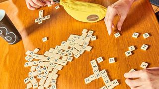Bananagrams being played on a wooden table