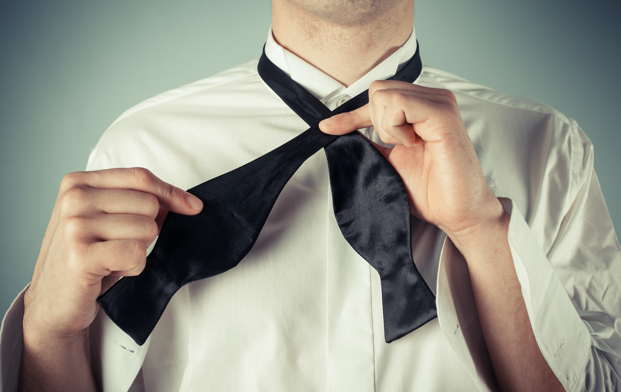 How to tie a bow tie: thread the long end over the short end